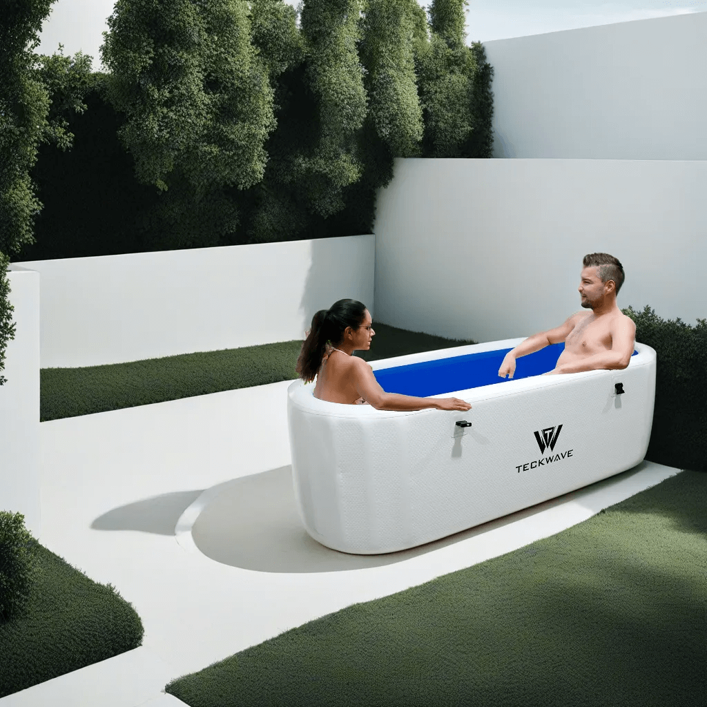 Two people relaxing in an Extra Large Ice Bath with TECKWAVE branding outdoors.