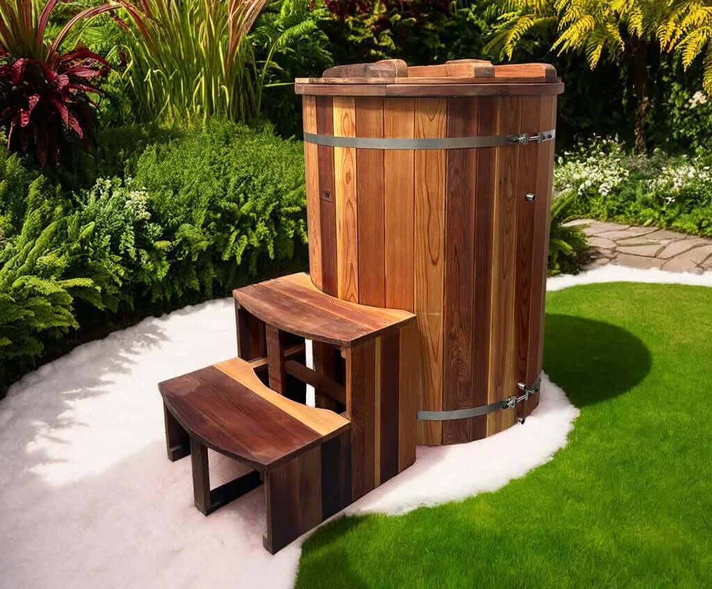 The Artisan Barrel Ice Bath with Chiller made from treated cedar in a lush garden setting.