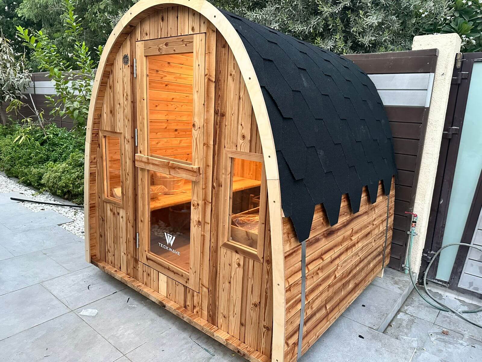 TECKWAVE ThermoElite ARC Sauna in yard of a villa