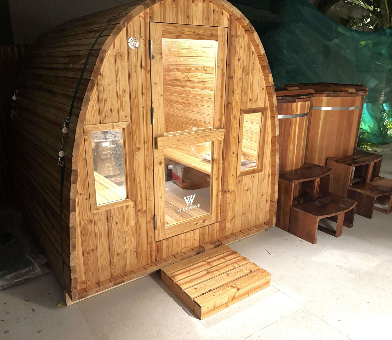 ThermoElite Arc Sauna next to two Artisan barrel ice bath
