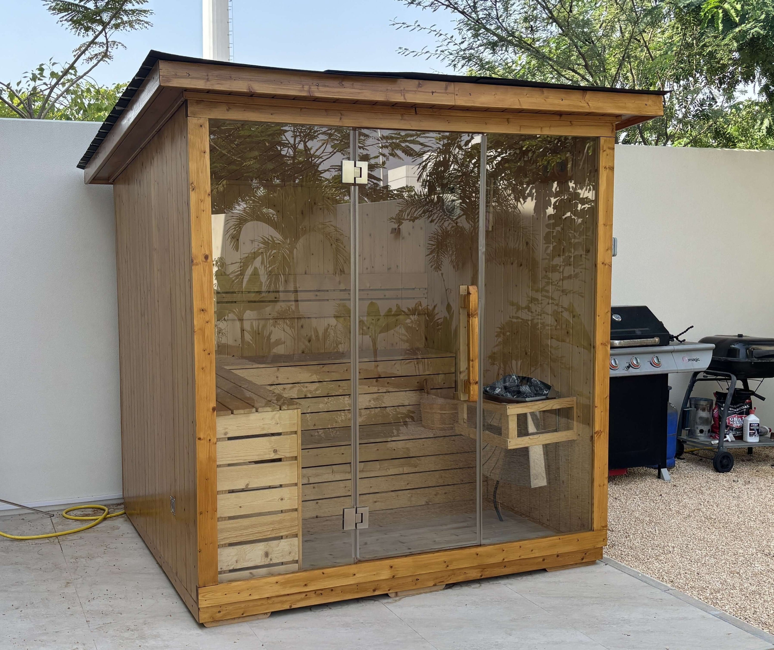 TECKWAVE ThermoElite Vista Sauna next to a BBQ
