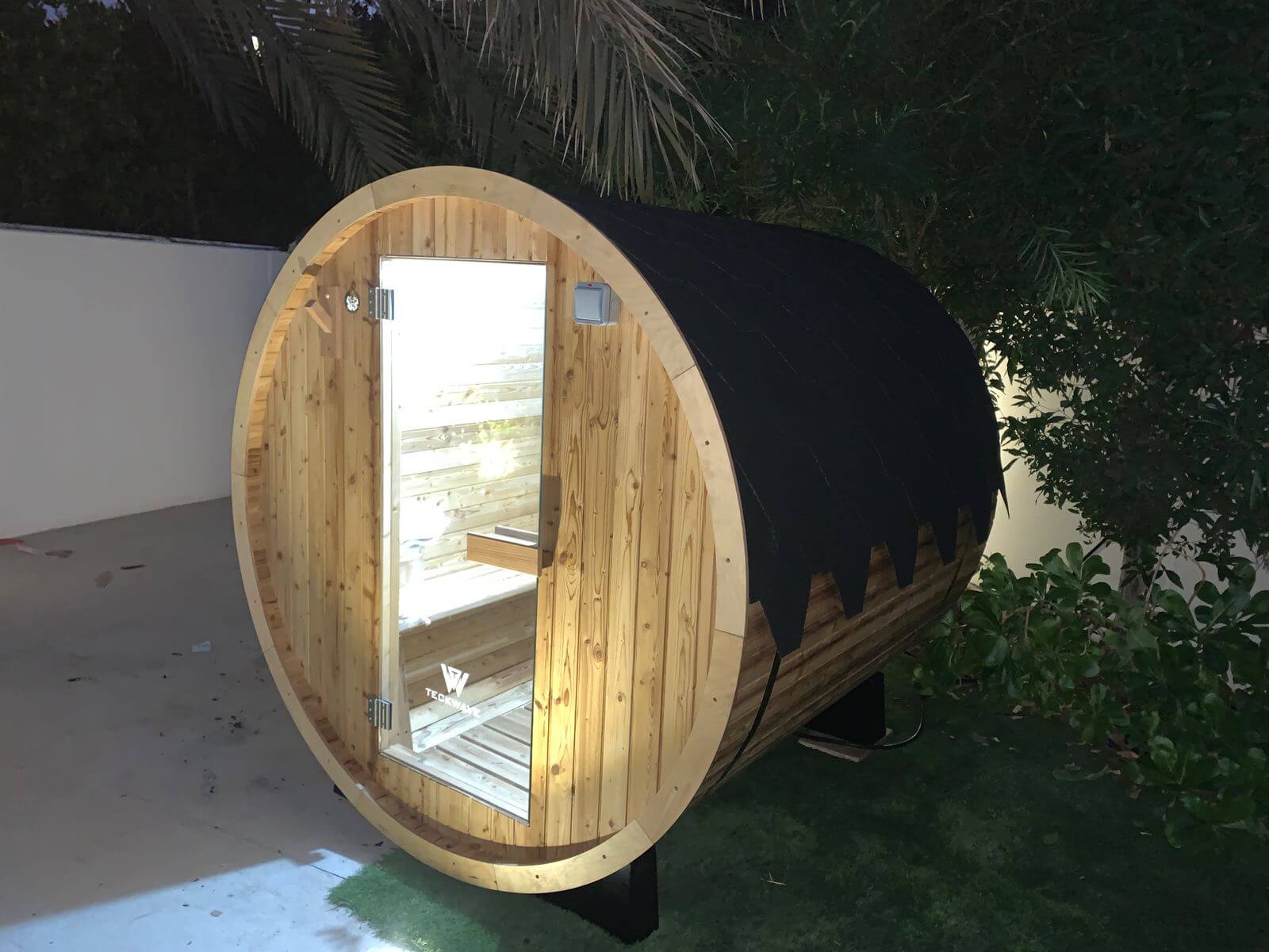 TECKWAVE ThermoElite barrel Sauna in the yard at night